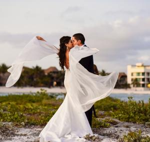 Bride wedding dress flying beach portraits blue venado mexico