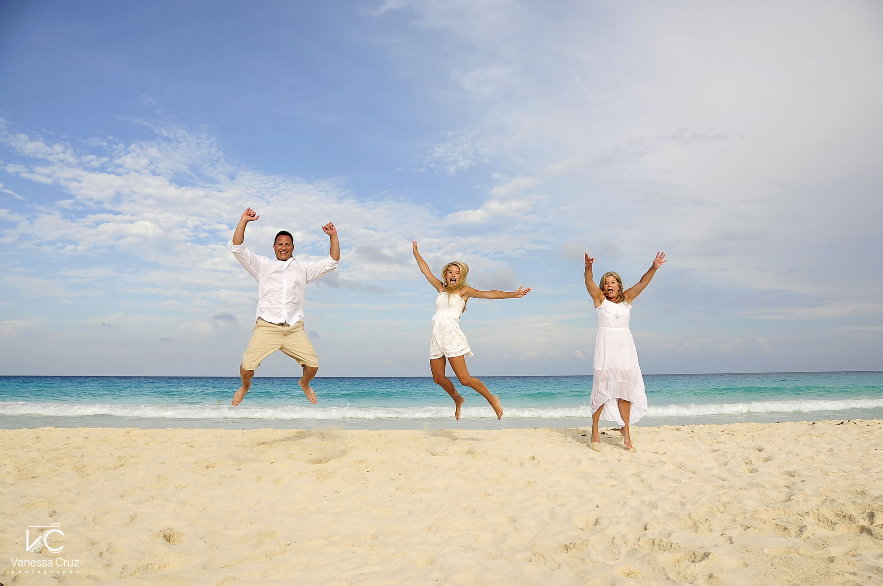 Jumping on beach family fun portraits Cancun Mexico