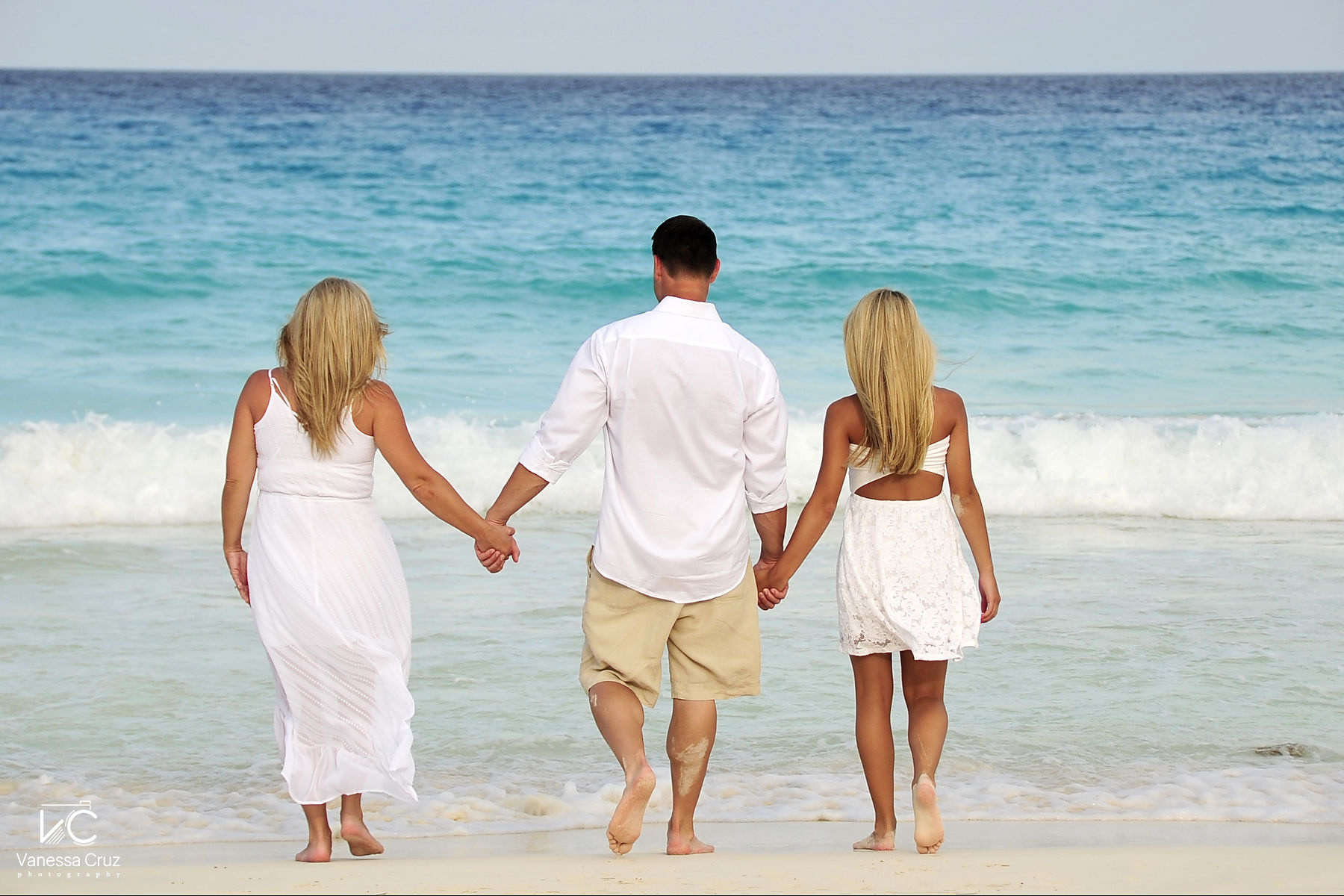 Family holding hands at Cancun beach Mexico