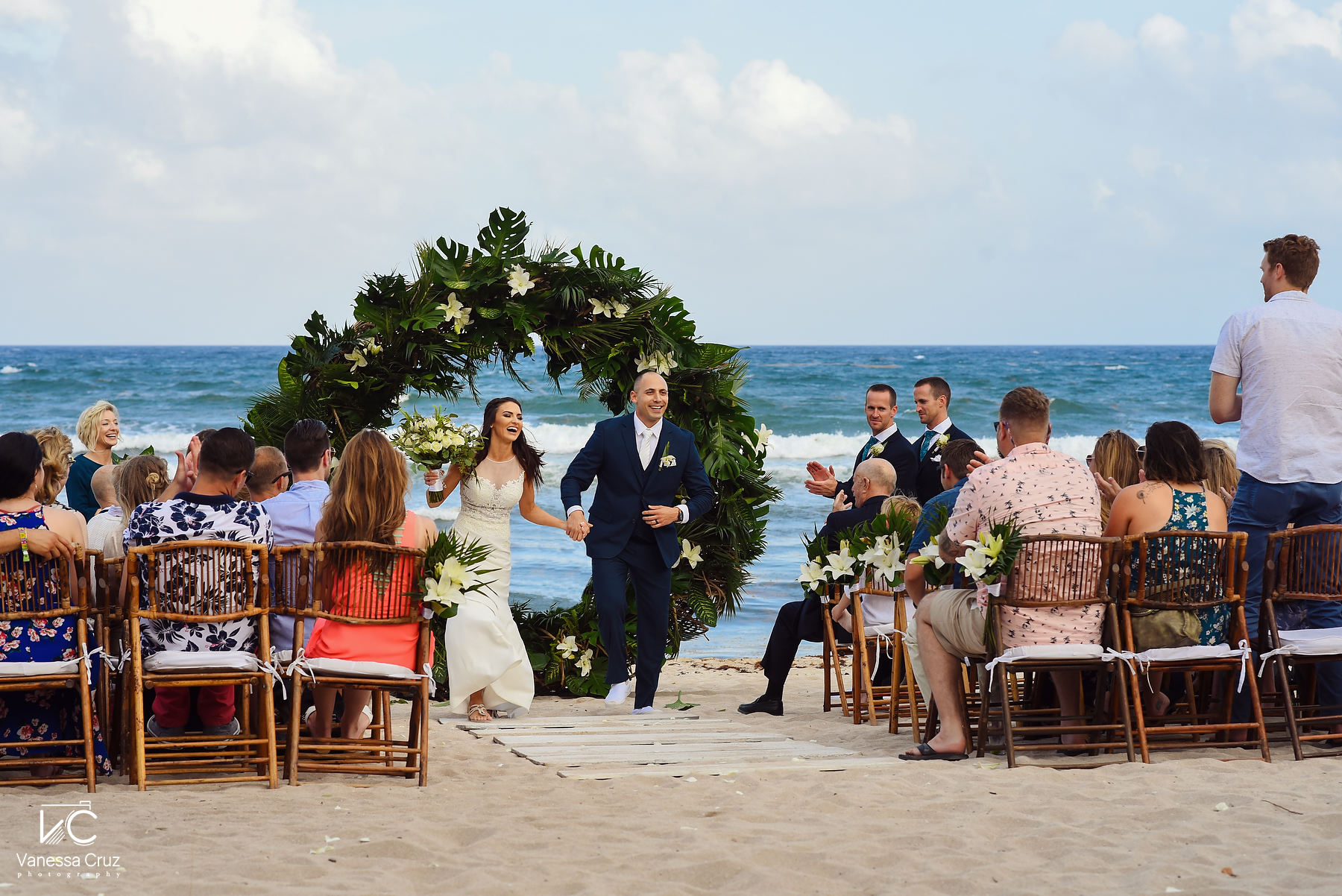 Bride and groom celebrating beach wedding ceremony Blue Venado Riviera Maya