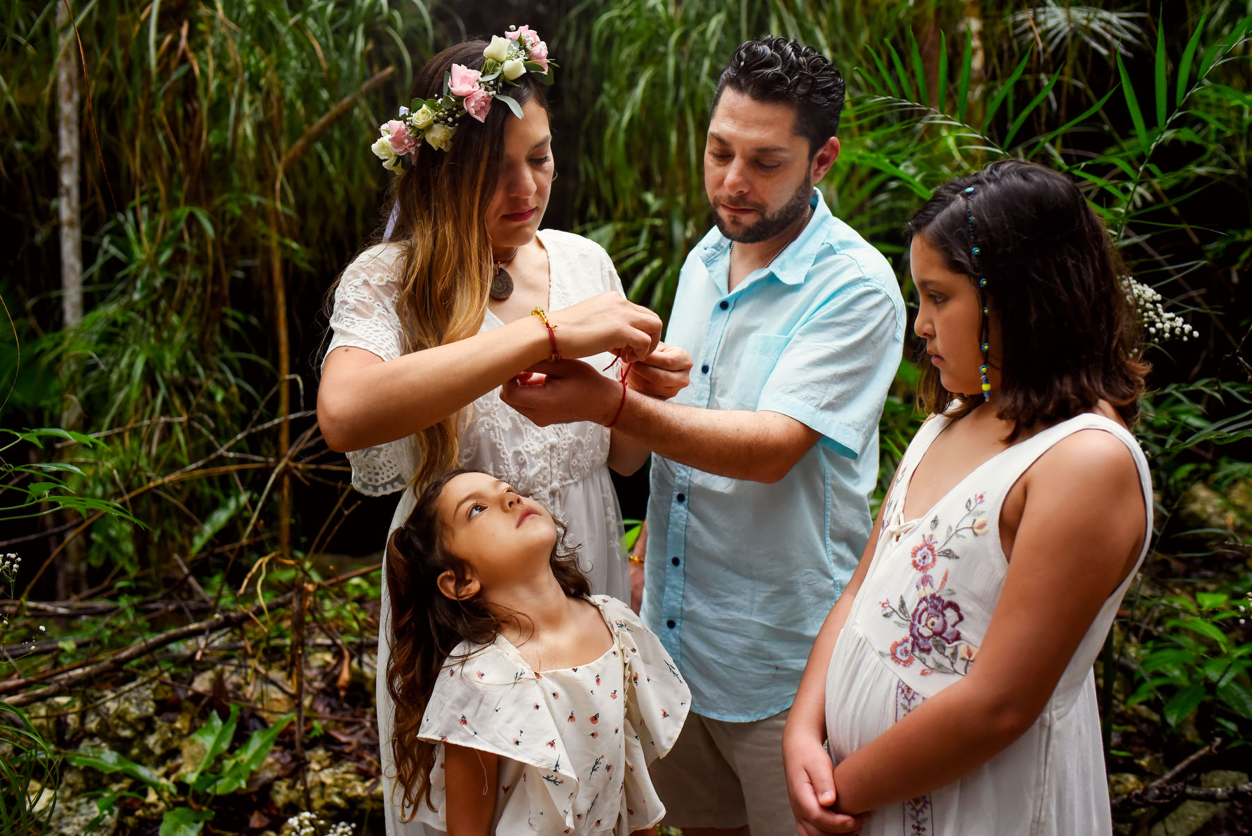 Family enjoying mayan ceremony blessing Cenote Tulum Mexico