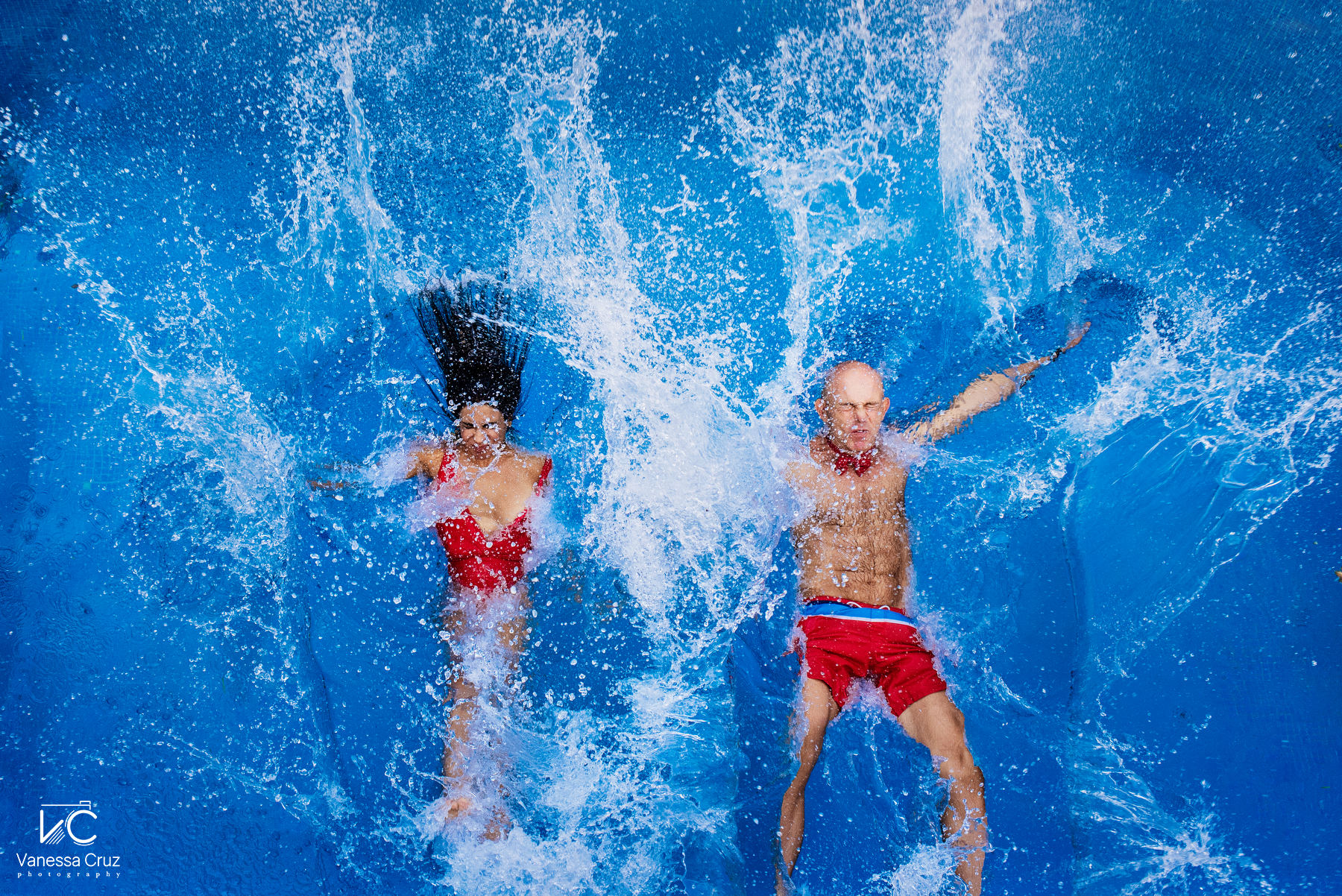 Couple jumps swimming pool anniversary photography  Playa del Carmen Mexico