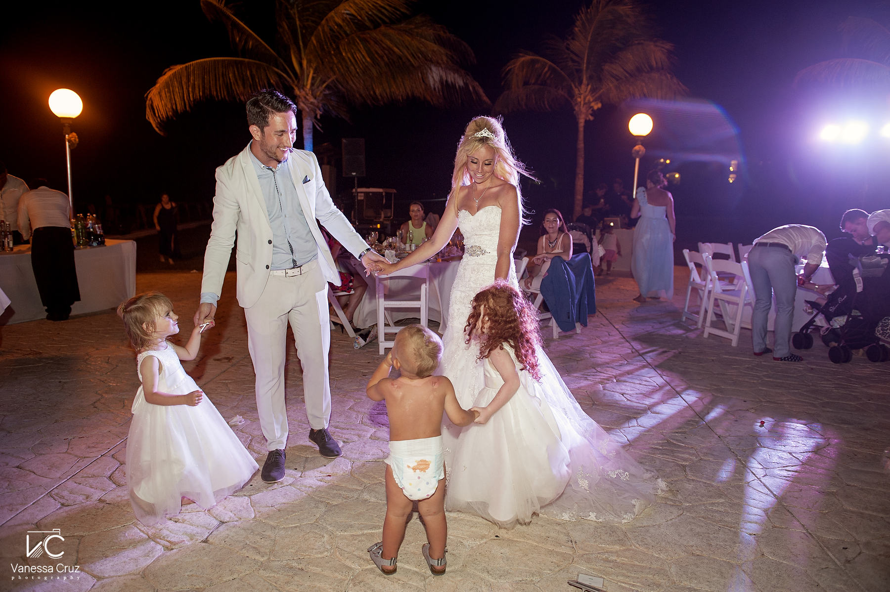 Bride and groom dancing with their children Moon Palace Cancun Mexico